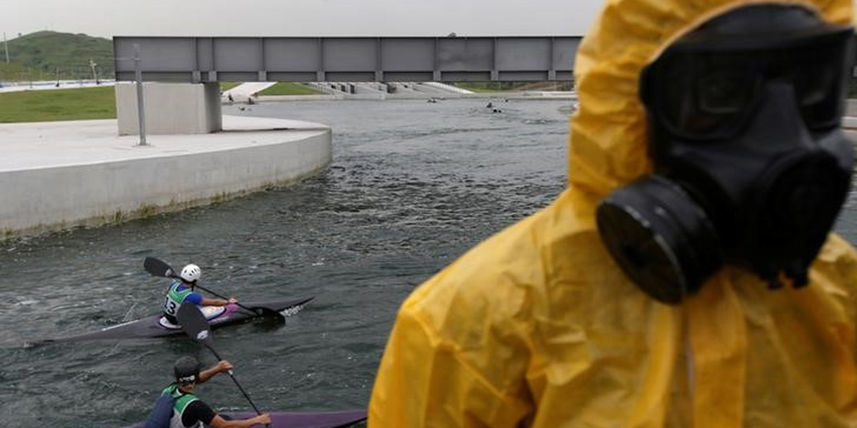 Athletes attend a training session at the 2016 Rio Olympics Games' Canoe Slalom Circuit as Brazilian army soldiers take part in a simulation of decontamination of multiple victims during training in Rio de Janeiro.