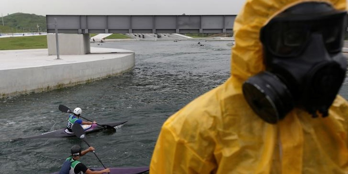 Athletes attend a training session at the 2016 Rio Olympics Games' Canoe Slalom Circuit as Brazilian army soldiers take part in a simulation of decontamination of multiple victims during training in Rio de Janeiro.