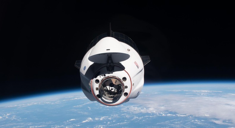 A Dragon spaceship approaches the International Space Station with astronauts aboard.NASA