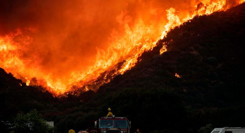 Firefighters battle wildfires in Southern California on Saturday.