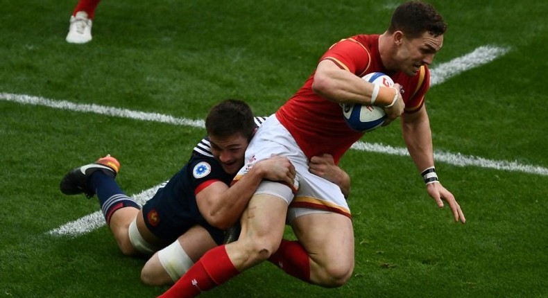 France's fullback Brice Dulin (L) tackles Wales' wing George North on March 18, 2017