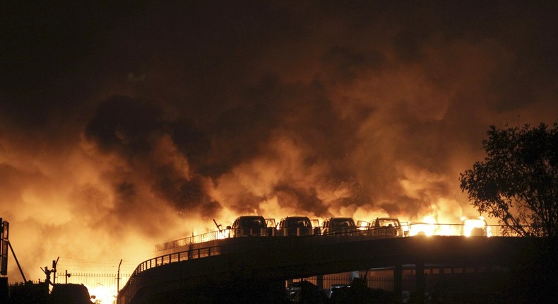 Vehicles are seen burning after blasts at Binhai new district in Tianjin municipality, China, on Thursday.