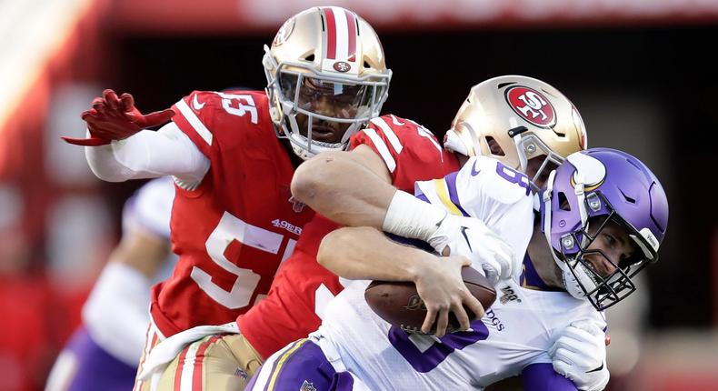 Minnesota Vikings quarterback Kirk Cousins, foreground, is tackled by San Francisco 49ers defensive end Nick Bosa, center, during the second half of an NFL divisional playoff football game, Saturday, Jan. 11, 2020, in Santa Clara, Calif. Also pictured at rear is defensive end Dee Ford. (AP Photo/Ben Margot)