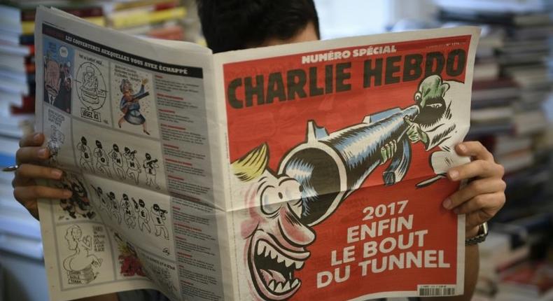 Charlie Hebdo marked the grim anniversary of the terror attack on its staff in typical style with a front-cover cartoon showing a laughing man staring down the barrel of a jihadist's rifle