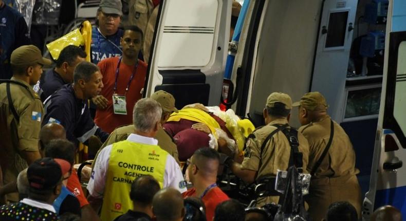 A woman is carried into an ambulance after being struck by the Paraiso do Tuiuti samba school float at the entrance of the Sambadrome during the first night of the Rio Carnival on February 26, 2017