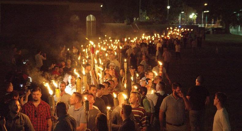 White nationalists carry torches on the grounds of the University of Virginia, on the eve of a planned Unite The Right rally in Charlottesville