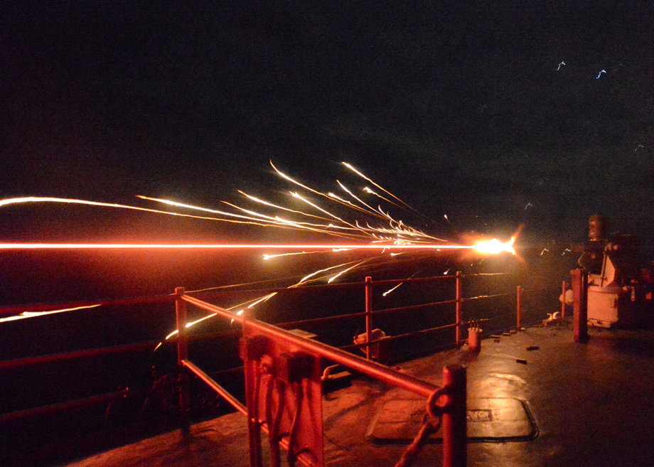 A 25 mm machine gun fires during a live-fire exercise aboard the amphibious dock landing ship USS Carter Hall.