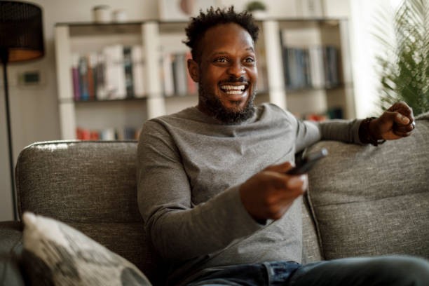 Man watching TV at home