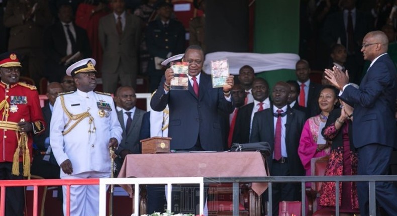 Preident Uhuru Kenyatta with CBK Governor Patrick Njoroge during the launch of new bank notes in Narok