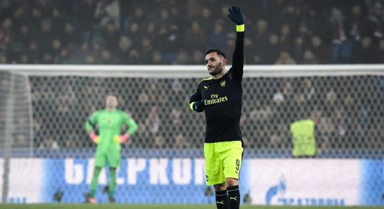 Arsenal's forward Lucas Perez (R) celebrates his third goal during the UEFA Champions league Group A football match between FC Basel 1893 and Arsenal FC on December 6, 2016 at the St Jakob Park stadium in Basel