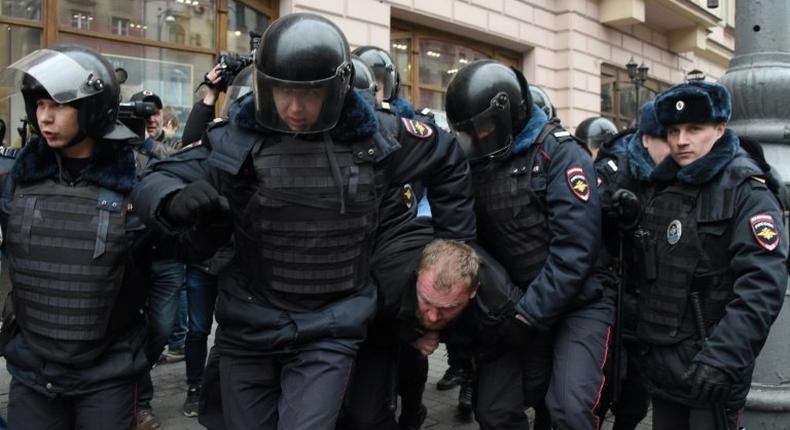 Russian police officers detain a man in central Moscow on April 2, 2017, as Russian opposition promised protests after police detained hundreds of people during anti-corruption rallies