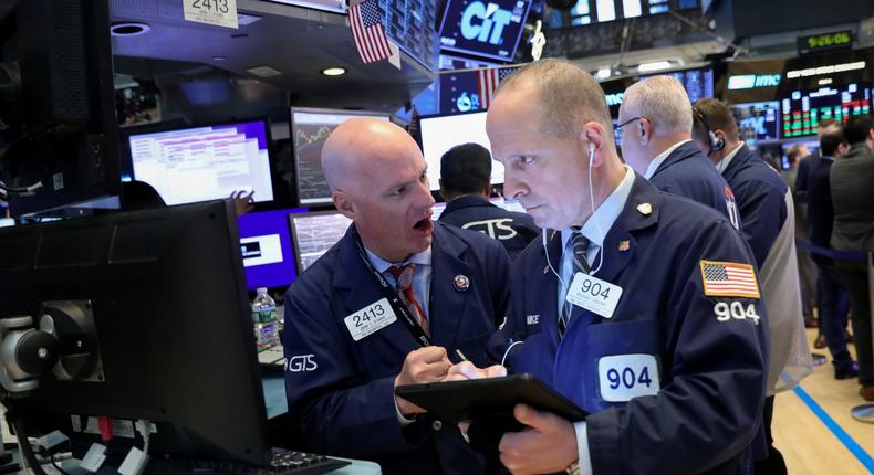 FILE PHOTO: Traders work on the floor at the New York Stock Exchange (NYSE) in New York, U.S., April 23, 2019. REUTERS/Brendan McDermid