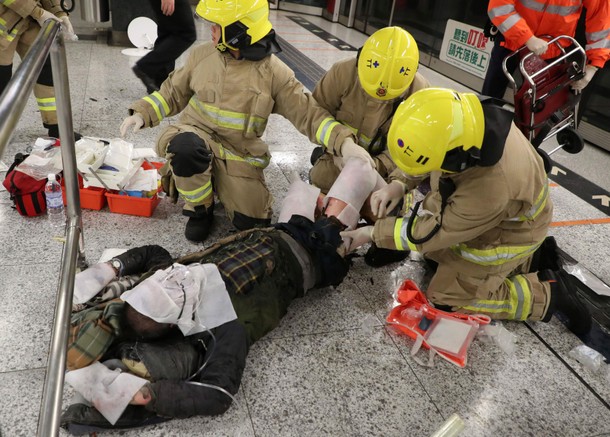 An injured person is under medical treatment inside a subway station in Hong Kong