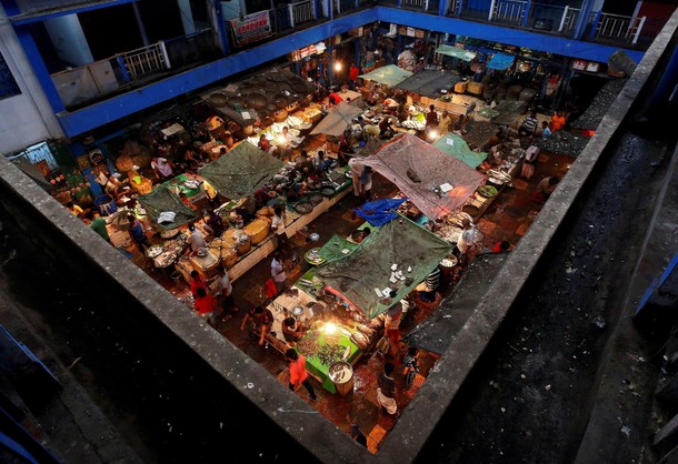 Vendors sell fish at a retail fish market in Kolkata