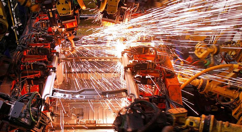 A crossover SUV vehicle is welded by robot arms as it goes through the assembly line at the General Motors Lansing Delta Township Assembly Plant March 10, 2010 in Lansing, Michigan. The Delta plant has more than 3,000 workers on two shifts and is expected to add a third shift of 900-1,000 workers in April. The plant produces the Buick Enclave, Chevrolet Traverse, and GMC Acadia crossover SUVs.