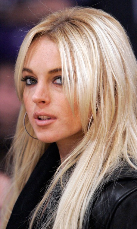 ** FILE ** Actress Lindsay Lohan is seen at the Los Angeles Lakers game against the Orlando Magic in their NBA basketball game, in this Dec. 2, 2007, file photo in Los Angeles. Court papers filed Tuesday, Dec. 4, 2007, allege the busboy who sued Lindsay Lohan has proof the actress had been drinking before she collided with his van in October 2005. Raymundo Ortega contends that Lohan drove her Mercedes-Benz into a van he was driving after she drank alcohol and later tried to escape paparazzi. He is seeking $200,000 in damages.  (AP Photo/Mark J. Terrill, file)