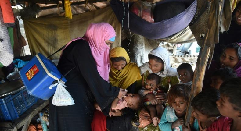 A Pakistani health worker administers drops to a child during a polio vaccination campaign in Lahore