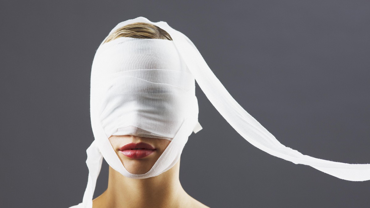 Bandage covering woman's face