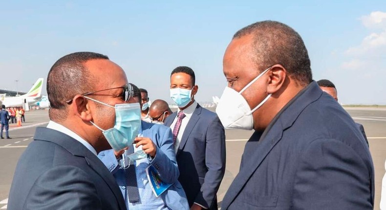 President Uhuru Kenyatta and Ethiopian Prime Minister Abiy Ahmed pictured at Bole International Airport in Addis Ababa on June 8, 2021