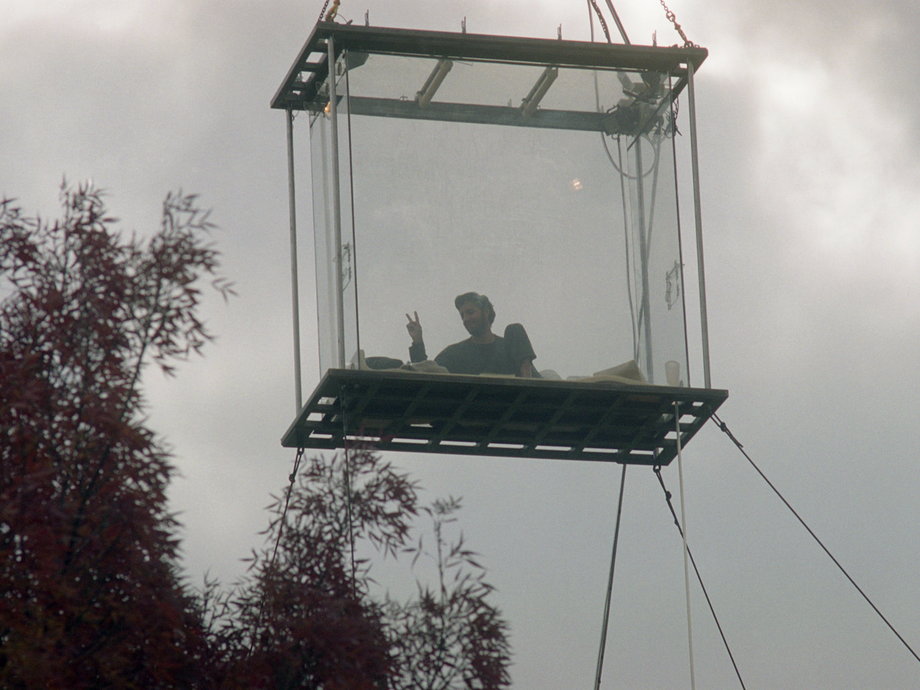 David Blaine at one of his stunts in 2003, in which he was suspended in isolation in a glass box over the Thames river for 44 days.