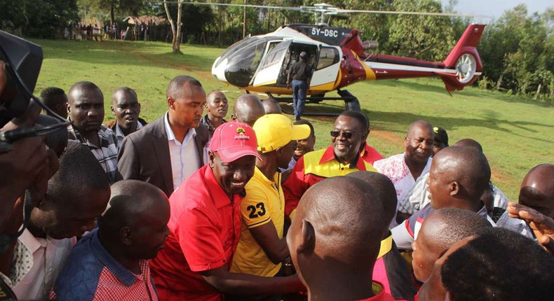 File image of Deputy President William Ruto (centre), and Labour Party of Kenya Leader Ababu Namwamba after alighting from a chopper