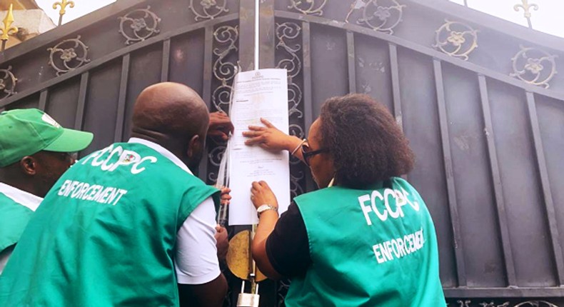 Officials of the FCCPC seal up a Chinese supermarket in Abuja.