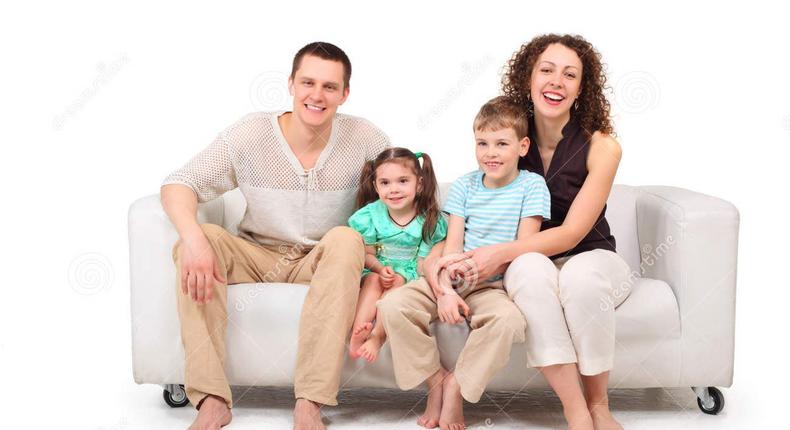 Family sitting on white leather sofa