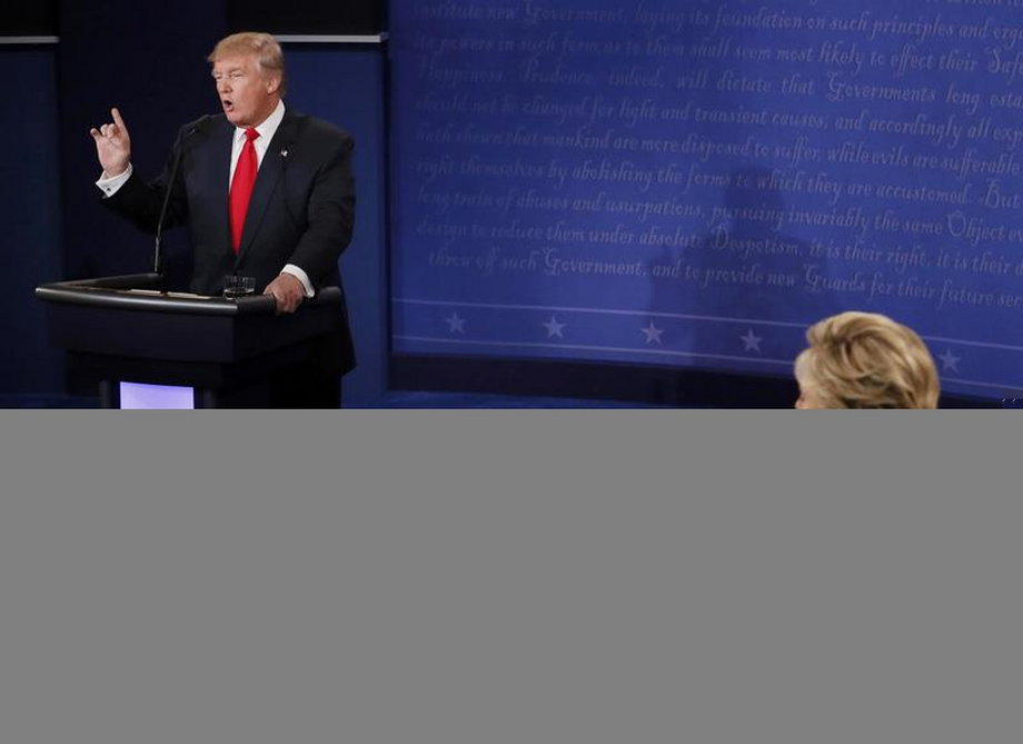 Trump speaks as Clinton listens during their third and final 2016 presidential campaign debate at UNLV in Las Vegas.