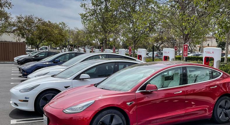 Tesla electric cars charge at a Supercharger.George Rose/Getty Images