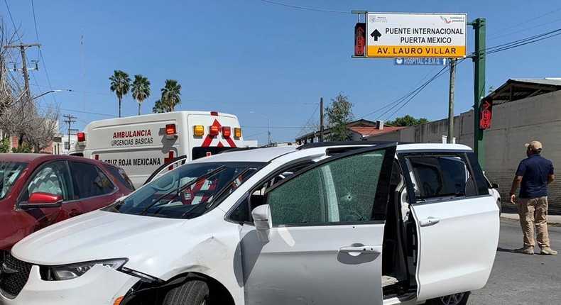 A member of the Mexican security forces stands next to a white minivan with North Carolina plates and several bullet holes, at the crime scene where gunmen kidnapped four U.S. citizens who crossed into Mexico from Texas, Friday, March 3, 2023.AP