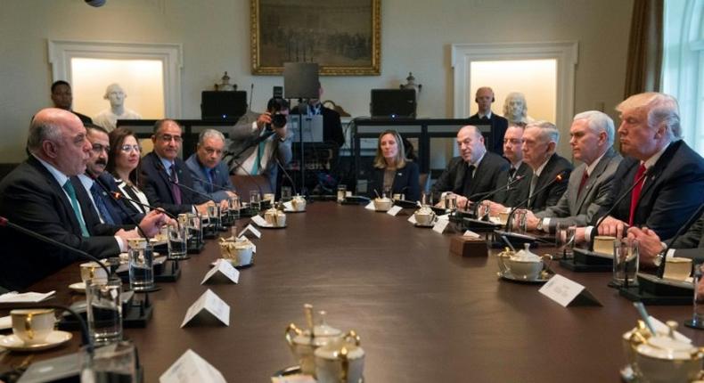 US President Donald Trump listens while Iraqi Prime Minister Haider Al-Abadi speaks during their meeting in the Cabinet Room in the White House on March 20, 2017