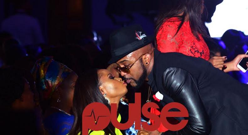 Banky W and Omowunmi Akinnifesi kissing at Elite Model Look 