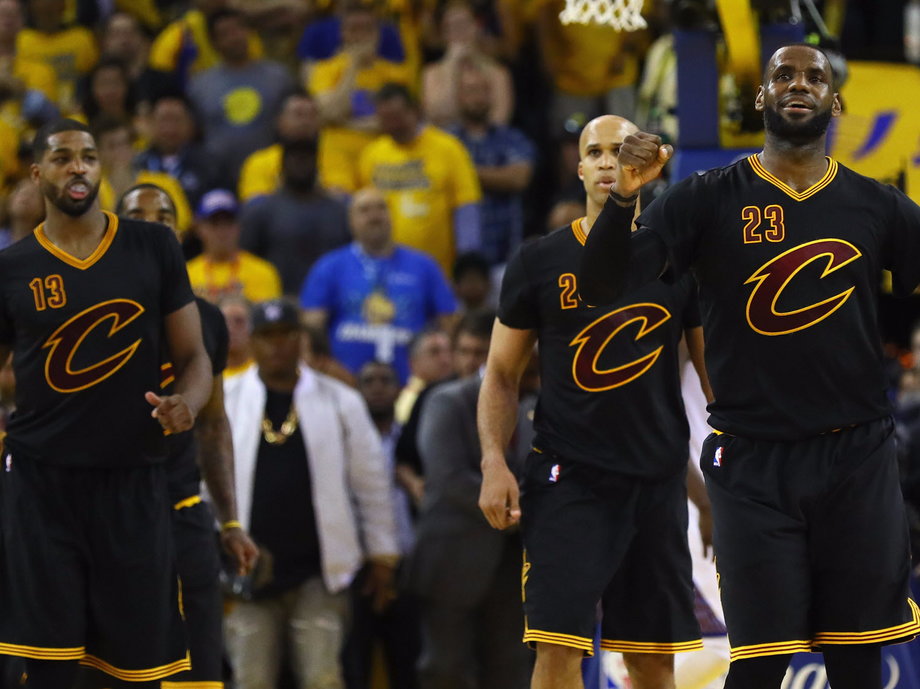 LeBron James and the Cavs celebrate in Game 7 of the 2016 NBA Finals while wearing sleeved jerseys.
