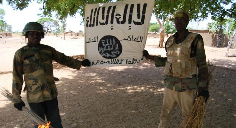 Some soldiers displaying Boko Haram flag after capturing their camps in Sambisa Forest.