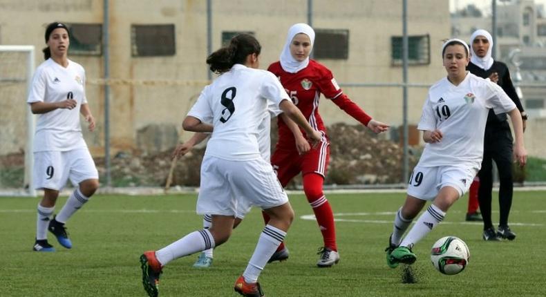 Players challenge for the ball in an exhibition game at Jordan's first women's football stadium in Amman on March 11, 2017