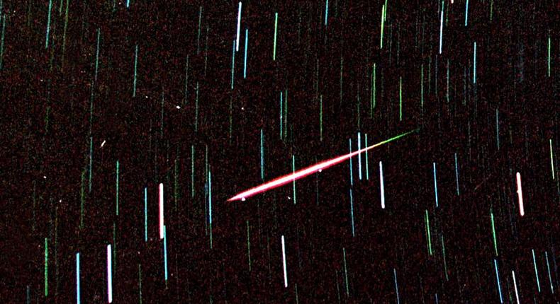 A Leonid meteor — a fragment of Comet Tempel-Tuttle — streaks across the night sky.