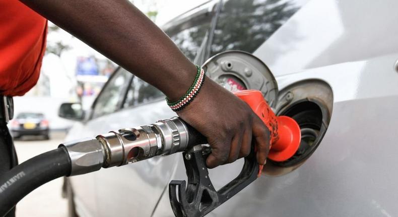 A pump attendant fills the tank of a car at a petrol station in September 4, 2018 in Nairobi as a 16 per cent VAT on petroleum products was decided and fuel distributors refused to collect stocks from depots. (Photo by SIMON MAINA/AFP via Getty Images)