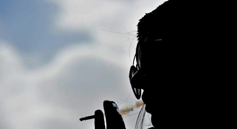 Saudi woman Heba smokes a cigarette at a cafe in Riyadh