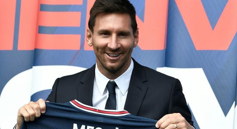 Welcome to Paris: Lionel Messi poses as he holds-up his number 30 shirt