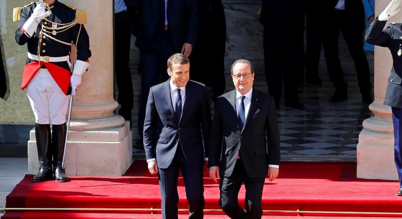 French President Emmanuel Macron (L) escorts former President Francois Hollande who leaves after the handover ceremony at the Elysee Palace in Paris, France, May 14, 2017