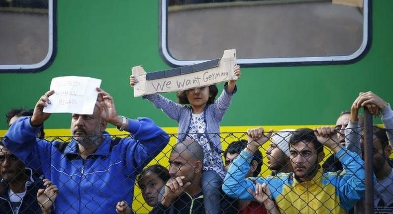 Migrants stage a protest in front of a train at Bicske railway station, Hungary, September 4, 2015. REUTERS/Leonhard Foeger