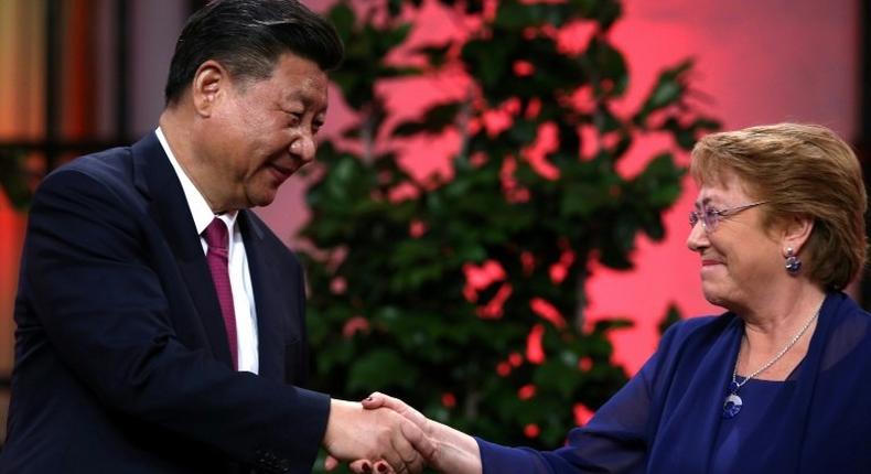 The two countries agreed on trade the move during a visit by Chinese President Xi Jinping (L) to Chile last year, where he is seen with Chilean President Michelle Bachelet (R)