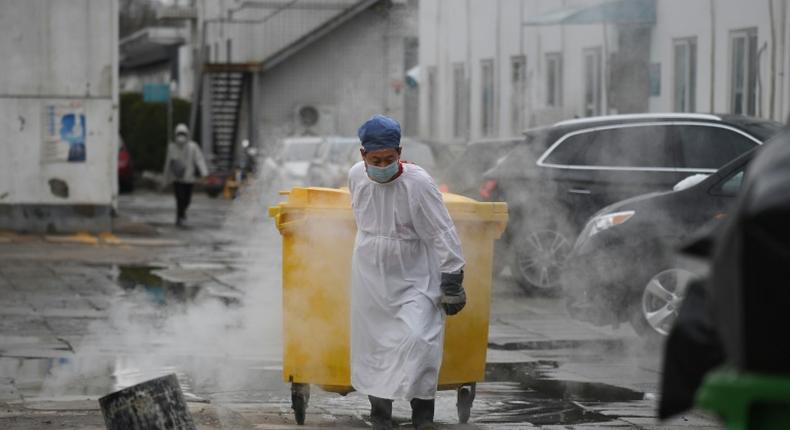 A worker moves medical waste at a hospital in Beijing treating coronavirus patients