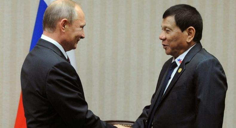 Philippine President Rodrigo Duterte (R) flies to Russia Monday to meet his hero Vladimir Putin, seen together on the sidelines of an APEC summit in Lima in 2016, seek arms and steer his nation's foreign policy course further away from longtime ally the United States