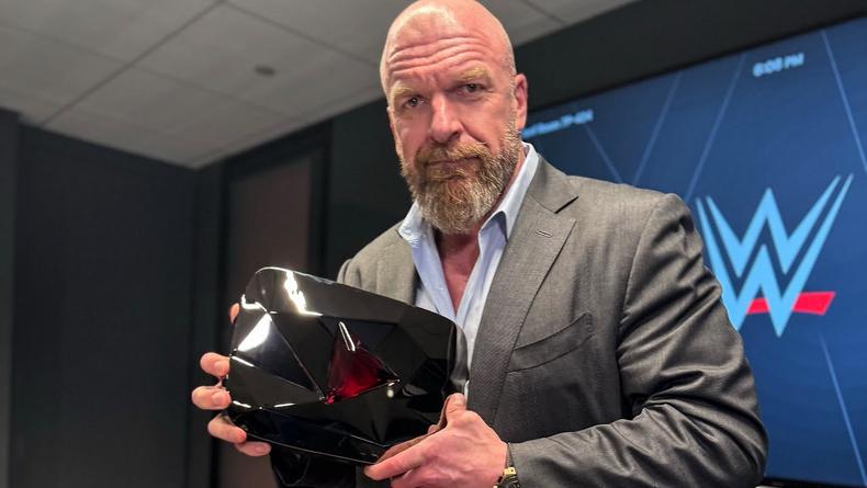 Triple H showing WWE's YouTube Red Diamond Play Button