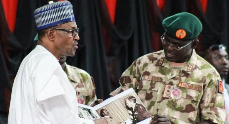 Nigerian President Muhammadu Buhari (left) meets top military in Maiduguri as part of a visit to troops on the front lines of the Boko Haram conflict which claimed another three soldiers' lives earlier this week.