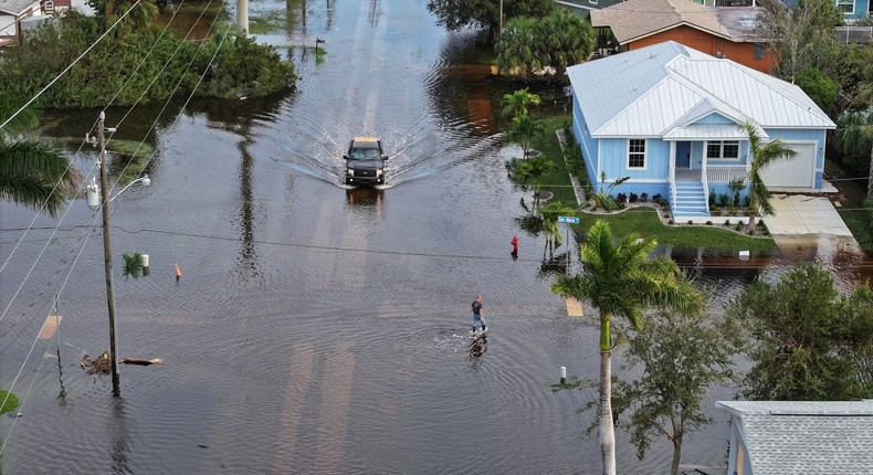 A car drives through a neighborhood in Central Florida impacted by Hurricane Milton.Joe Raedle/Getty Images