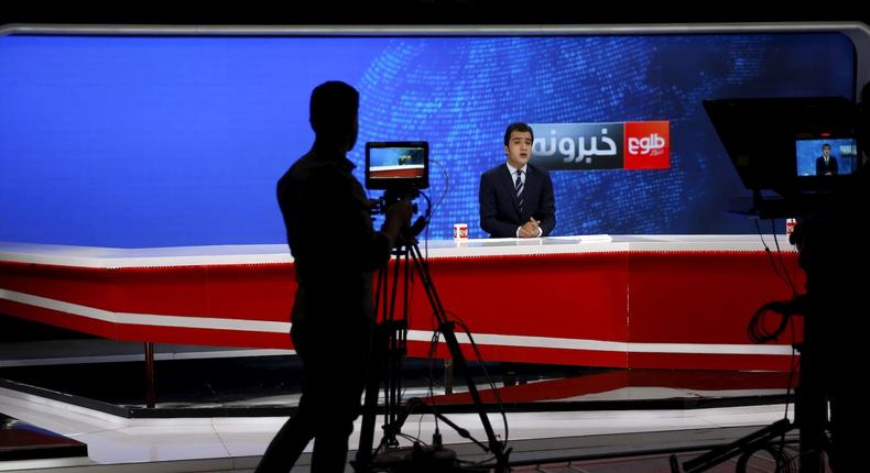 FILE PHOTO: A cameraman films a news anchor at Tolo News studio, in Kabul, Afghanistan October 18, 2015. Female journalists face increasing threats to their jobs and lives in Afghanistan under Taliban rule.
