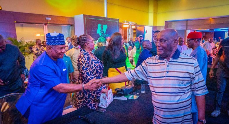 PDP presidential candidate, Abubakar Atiku shaking hands with filmmaker, Francis Onochie. 