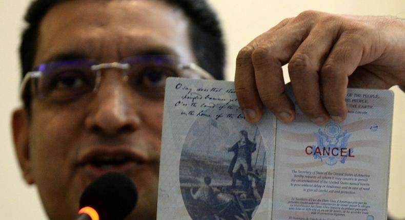 Lawyer Ali Sabry holds a document that is purportedly the cancelled US passport of Sri Lanka presidential candidate Gotabhaya Rajapakse